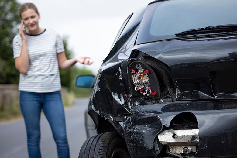 girl on phone after car accident