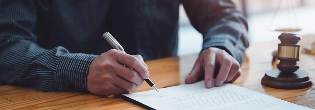 man signing insurance paperwork