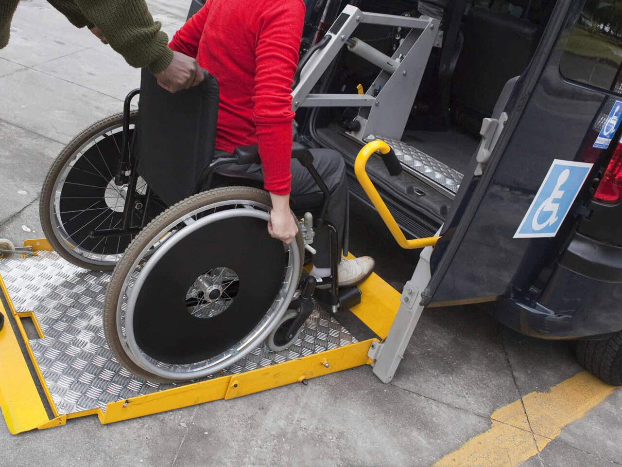 Wheelchair user on van ramp