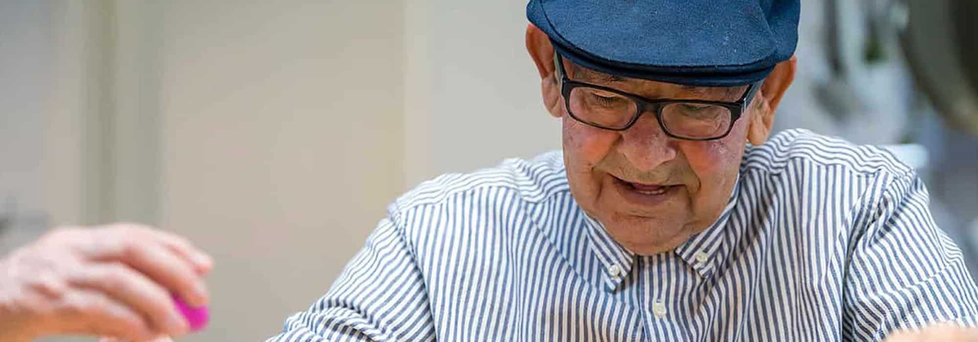 Elderly man playing games at adult daycare