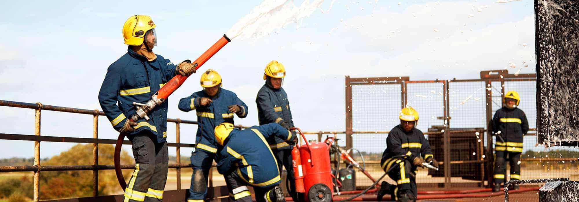 Firemen using foam