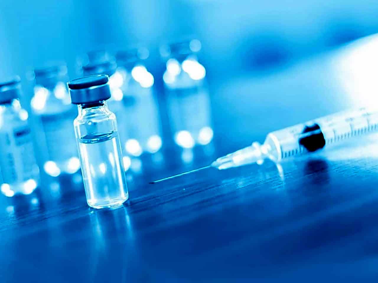 Injectible medicine and syringe on counter