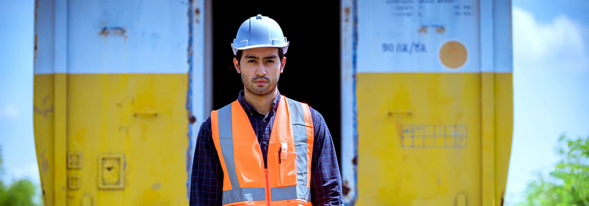 Railroad worker in front of rail car
