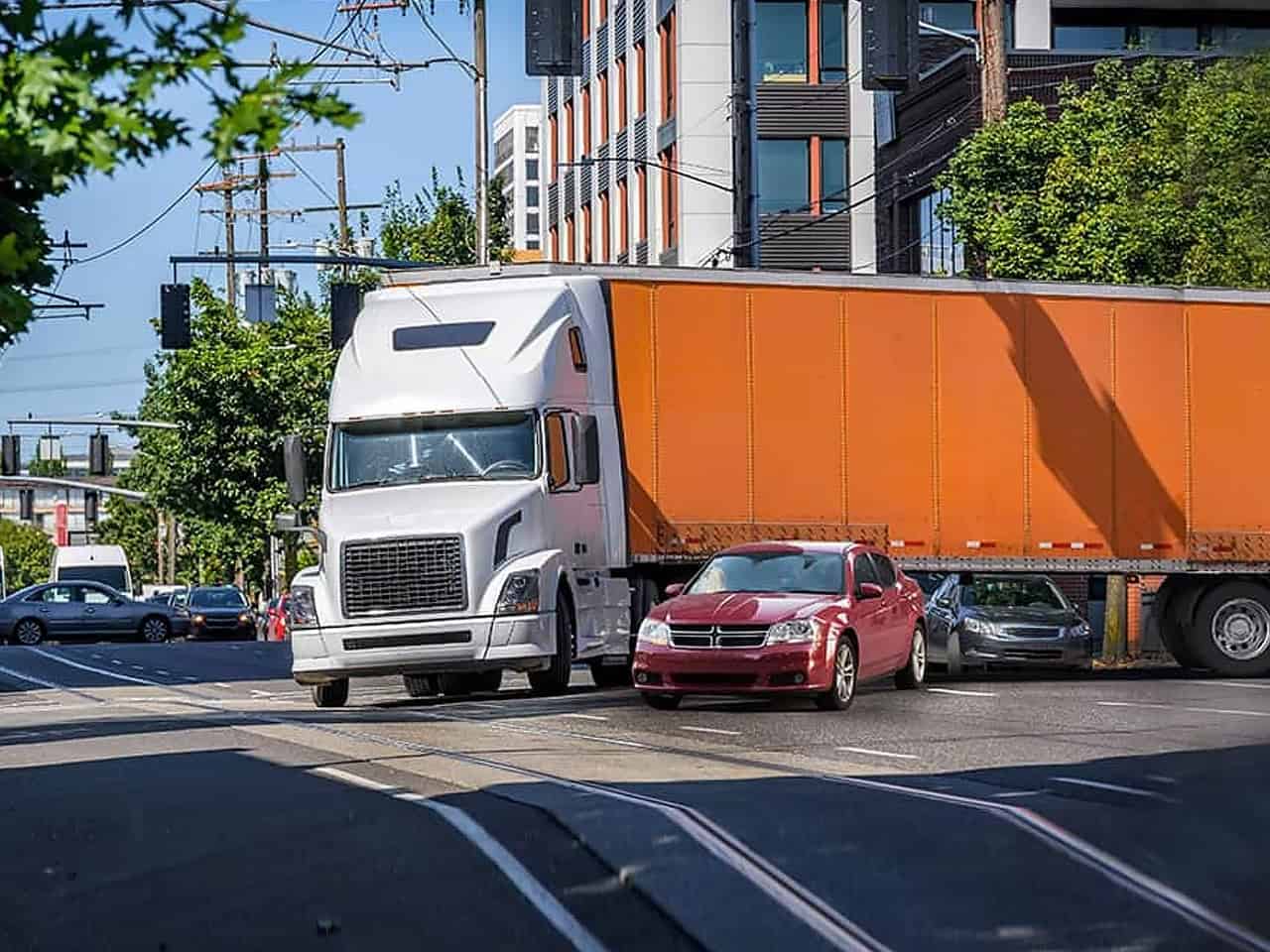 Truck taking a wide turn hitting a car
