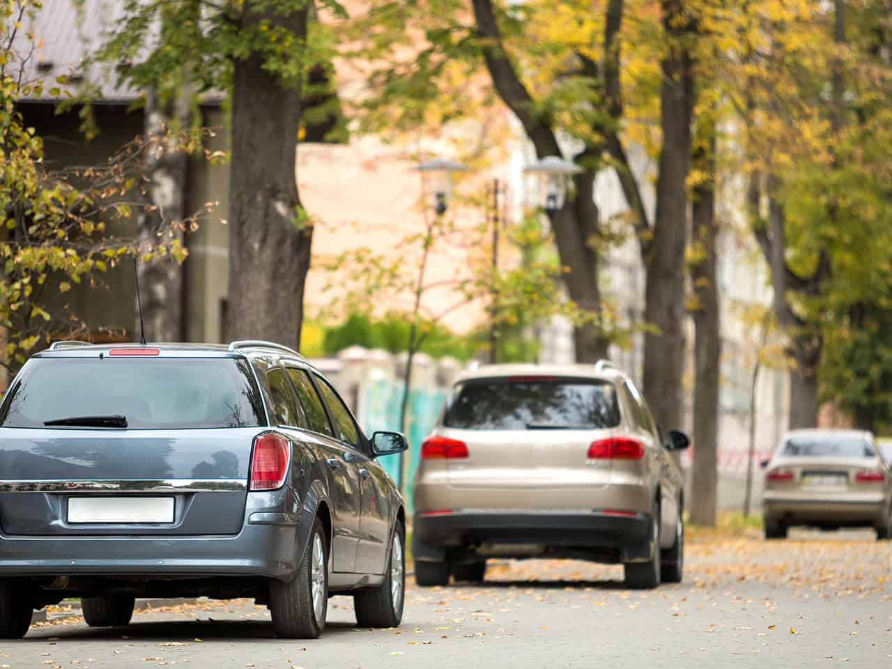 Cars in small town parked on side of the road