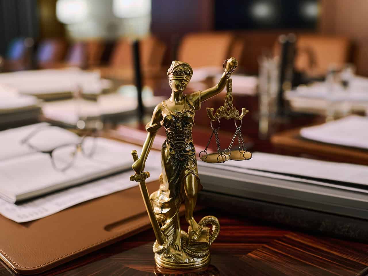 Lady justice on desk with papers