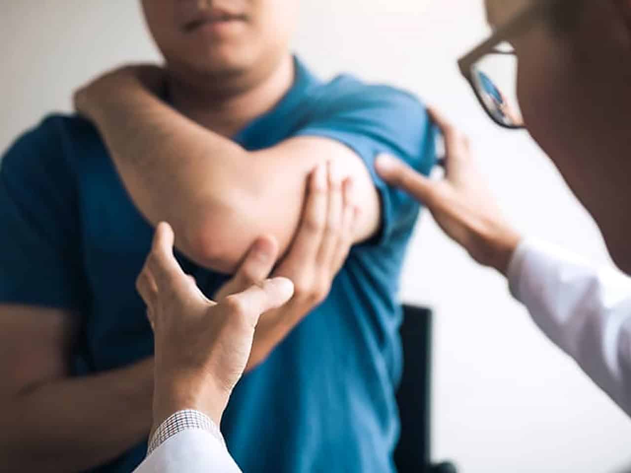 Man getting elbow examined at doctor