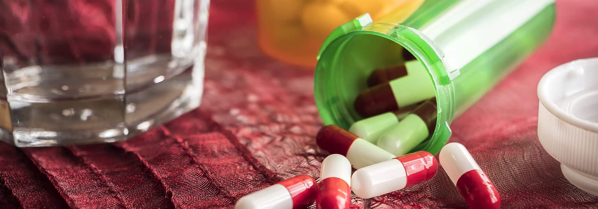 Open medication bottle on table