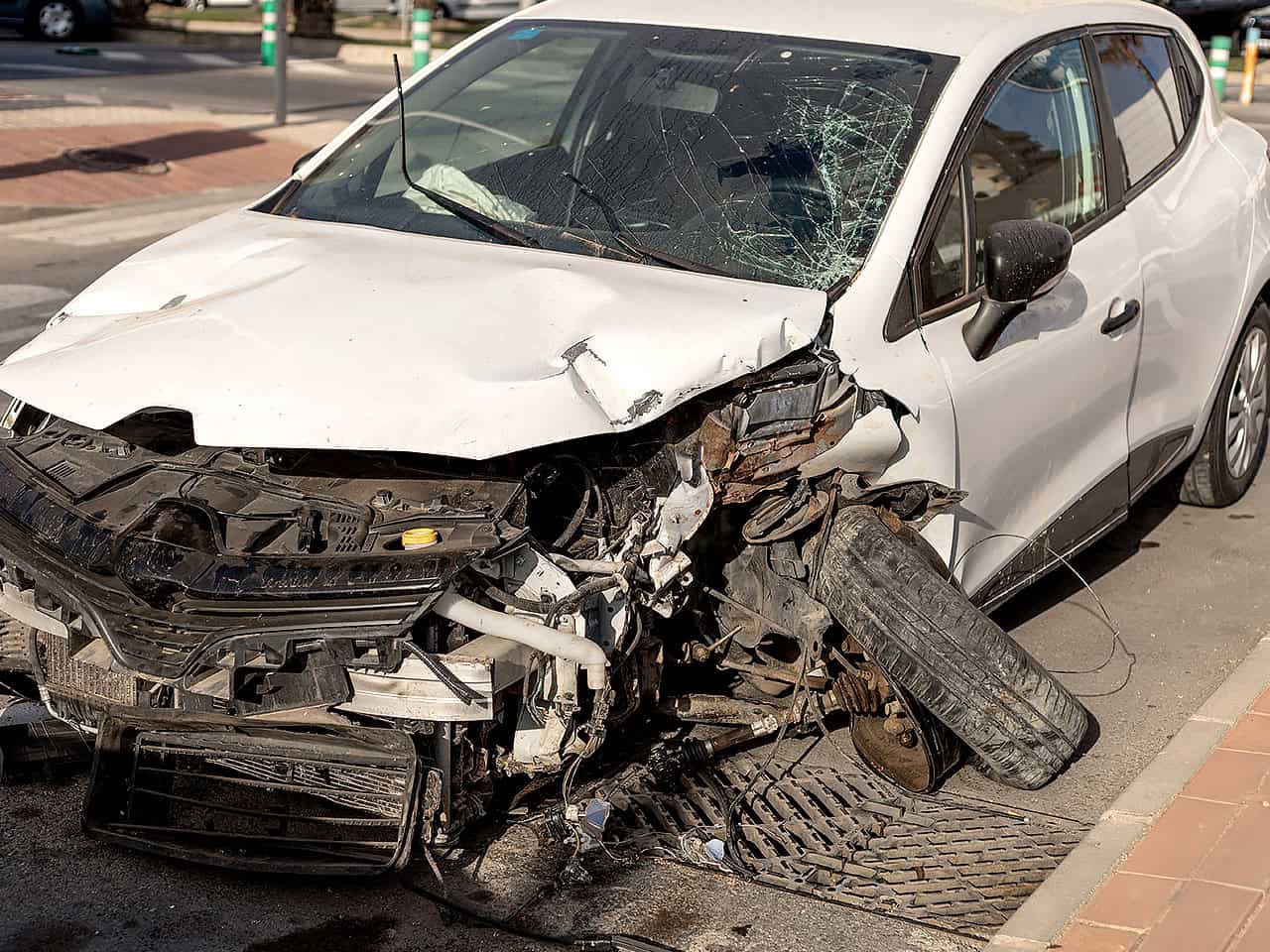 White sedan severely damaged