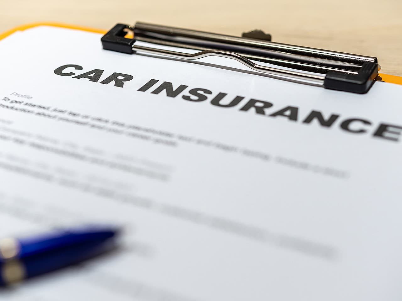 Car insurance paperwork on clipboard