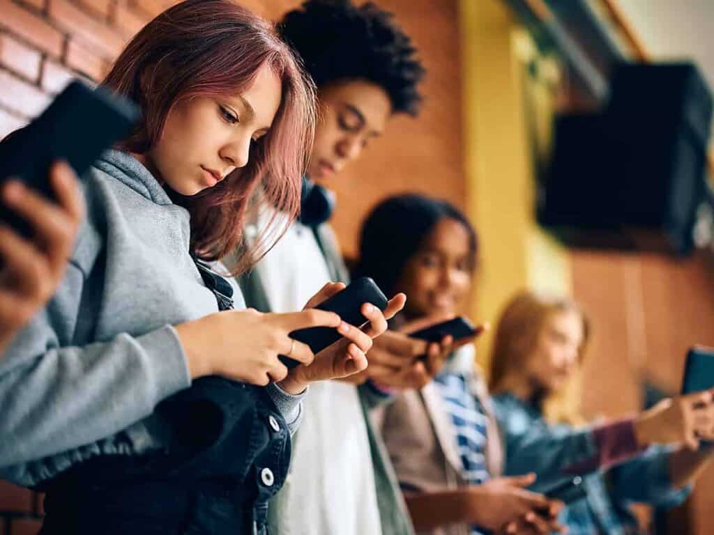 Group of teens staring at their phones