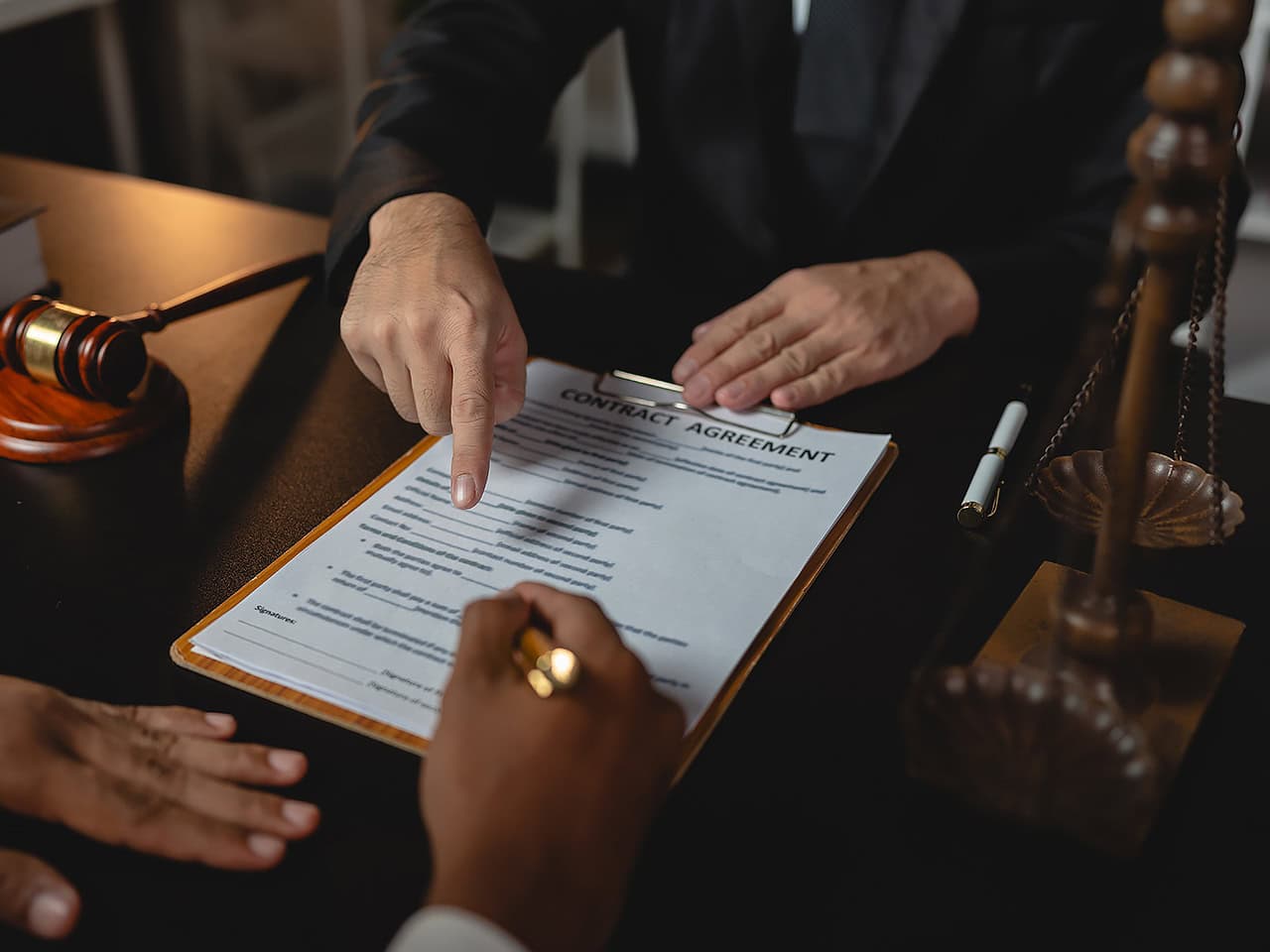 Lawyer and client reviewing contract